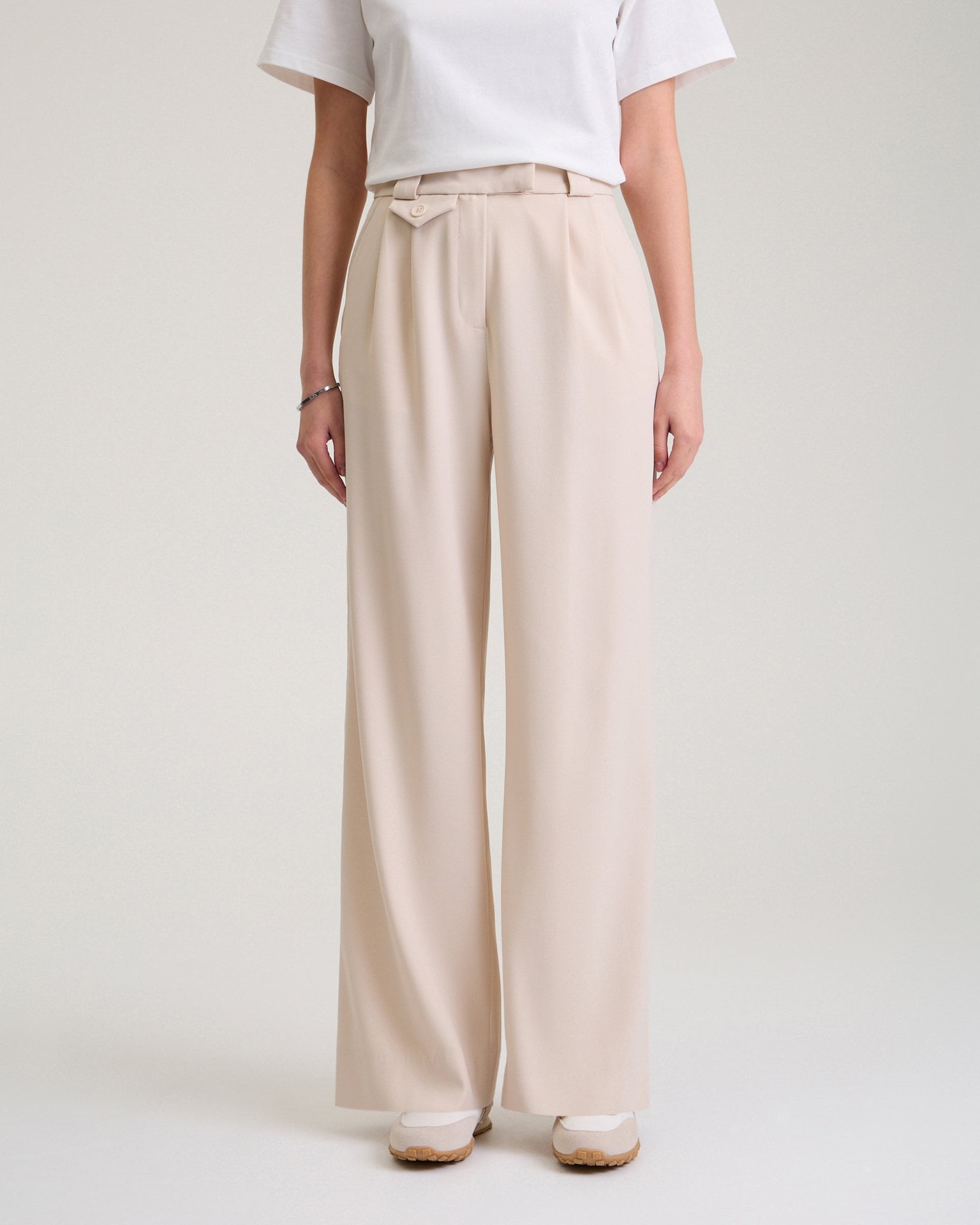 Trousers with a decorative pocket in beige