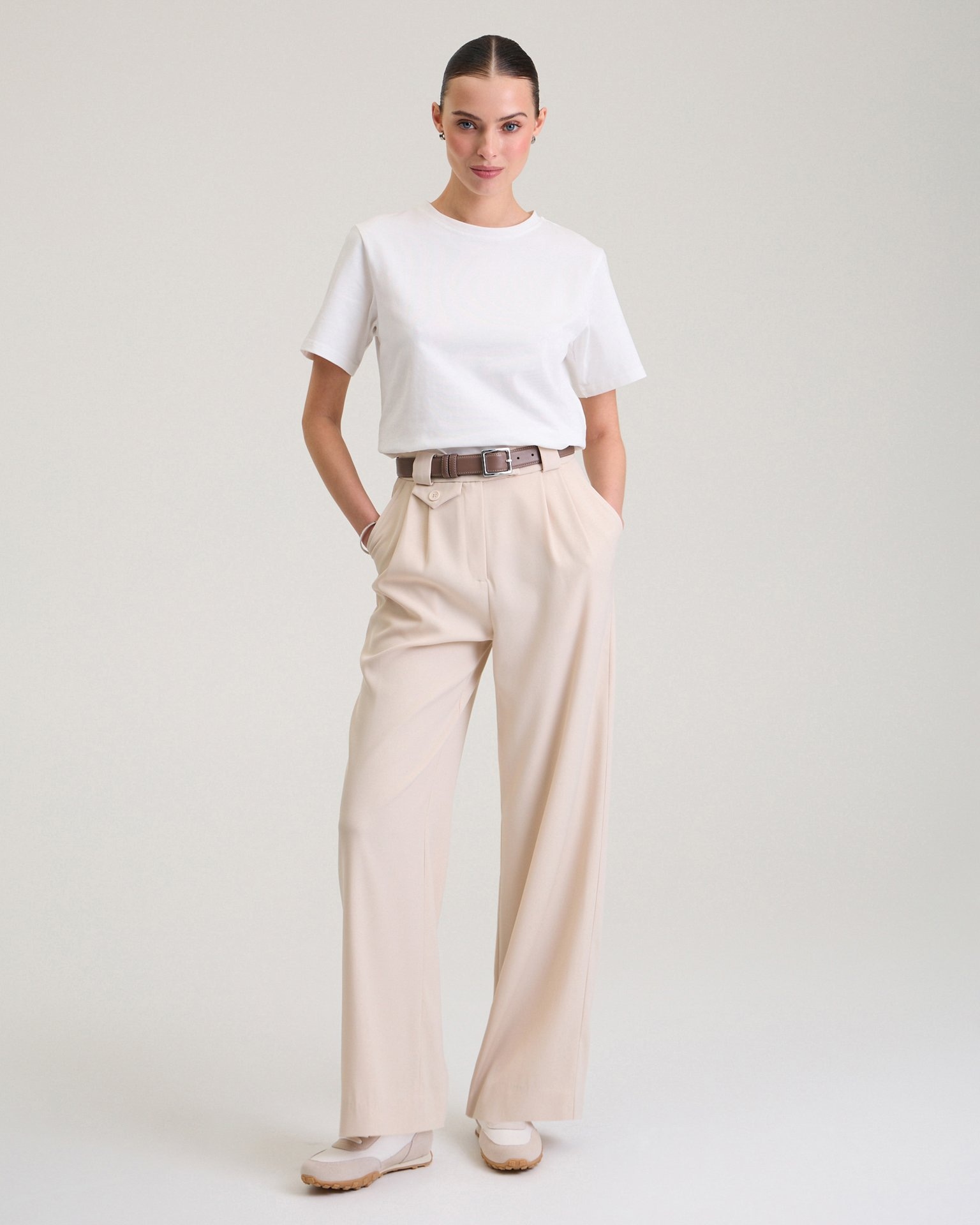 Trousers with a decorative pocket in beige
