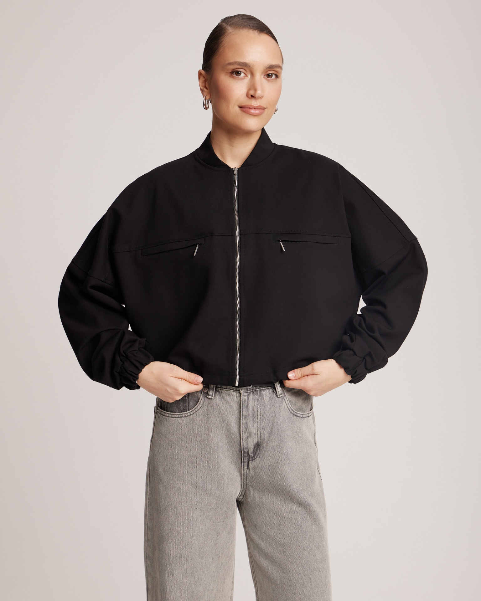Black bomber jacket with adjustable ribbed hem